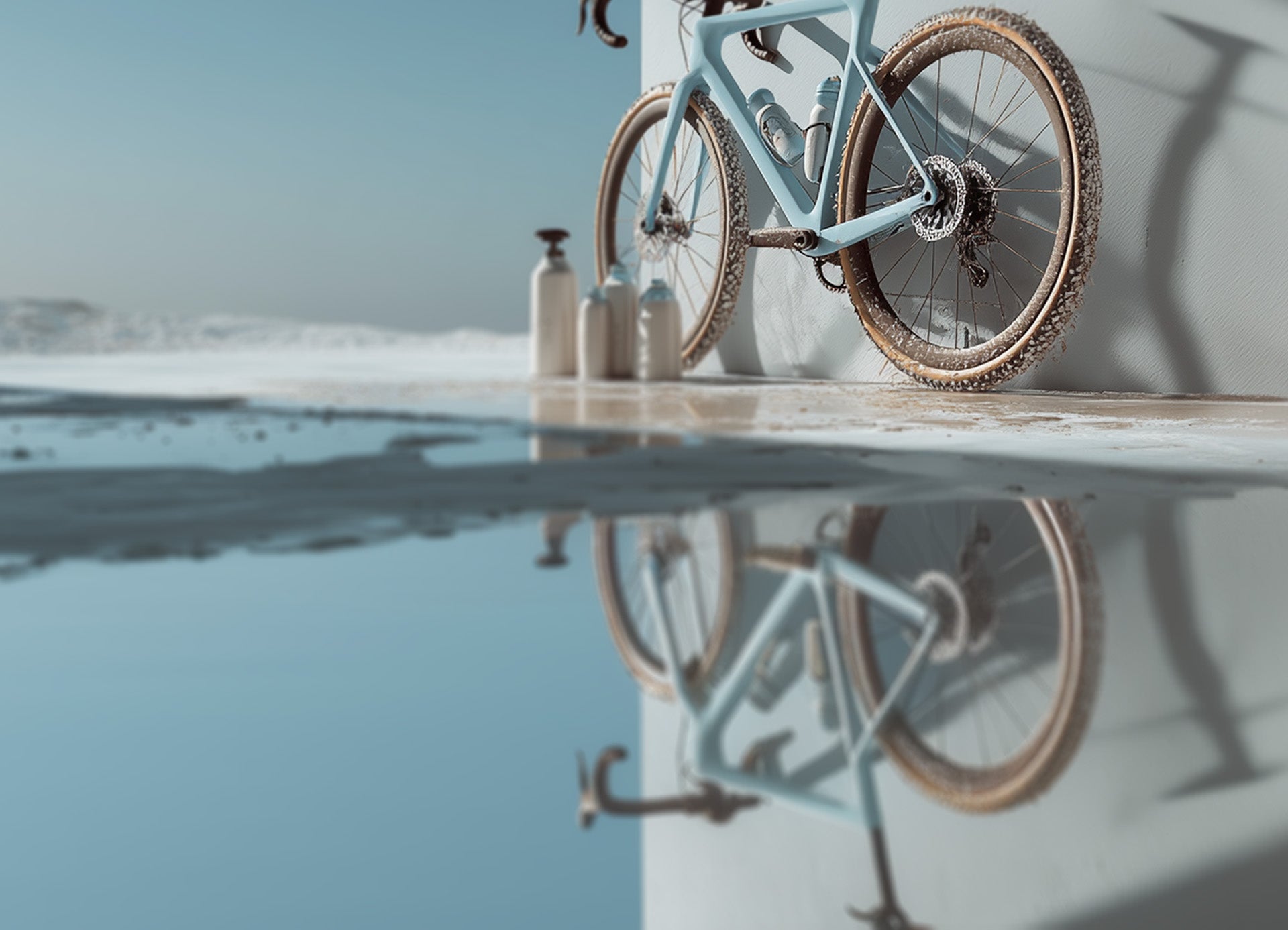 Dirty bicycle in the winter sun with cleaning bottles by the wheel in preparation for cleaning.