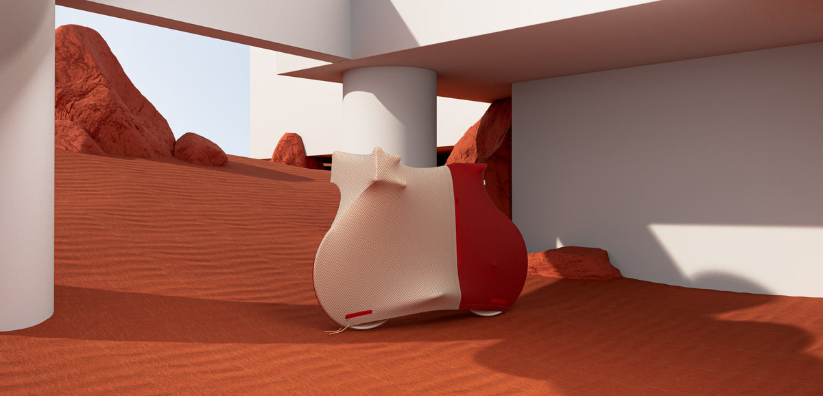 NX1 bicycle enclosure in Hackney Wool colourway, red and herringbone two-tone, side view with front and side zips, on a reddish-orange desert dune under a white architectural structure background.